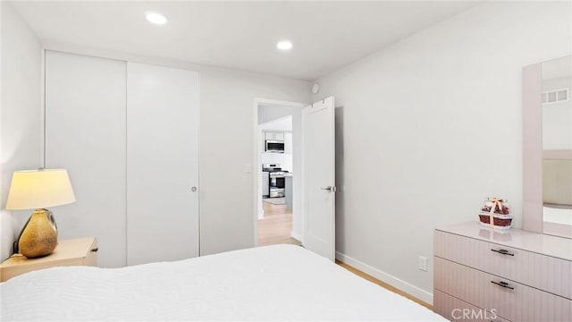23208 Cuervo Dr, Valencia, CA 91354 - bedroom featuring recessed lighting, a closet, and wood finished floors