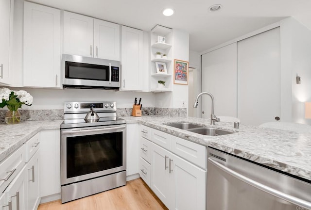 4600 Lamont St Unit 106, San Diego, CA 92109 - kitchen with stainless steel appliances, open shelves, white cabinets, light wood-style floors, and recessed lighting