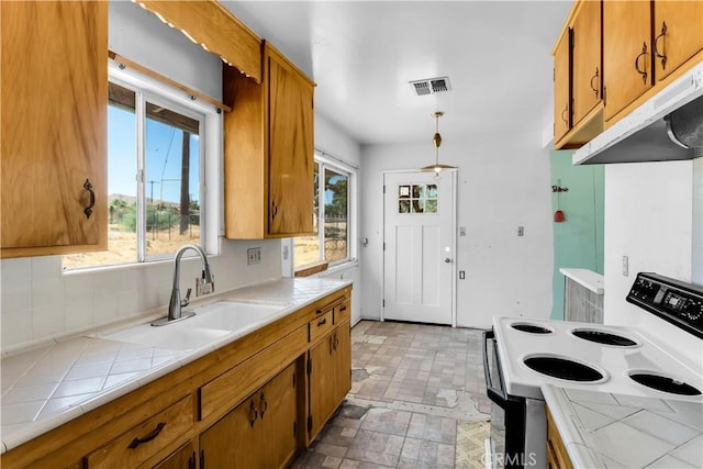 57136 Navajo Trl, Yucca Valley, CA 92284 - kitchen featuring white electric range oven, tile countertops, ventilation hood, and brown cabinets