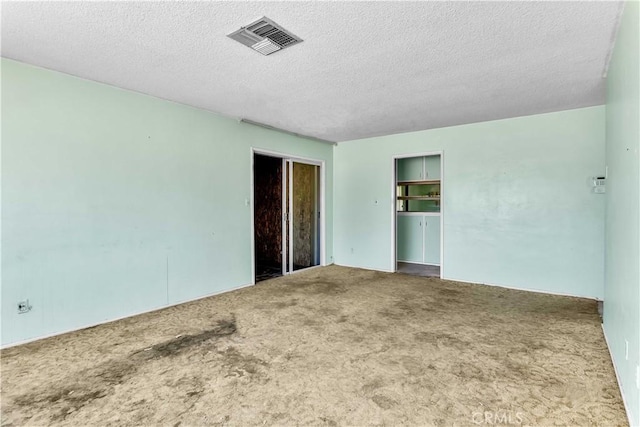 57136 Navajo Trl, Yucca Valley, CA 92284 - empty room featuring carpet floors and a textured ceiling