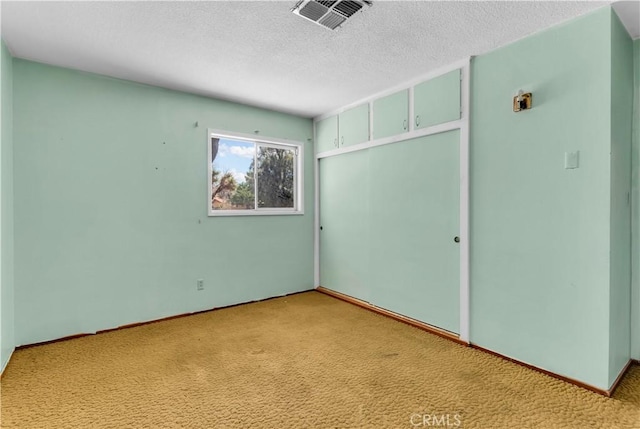 57136 Navajo Trl, Yucca Valley, CA 92284 - unfurnished bedroom featuring carpet floors, a closet, and a textured ceiling