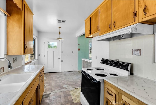 57136 Navajo Trl, Yucca Valley, CA 92284 - kitchen featuring white electric stove, tile countertops, under cabinet range hood, and tasteful backsplash