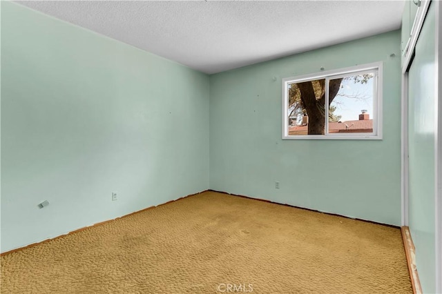57136 Navajo Trl, Yucca Valley, CA 92284 - unfurnished room with light carpet and a textured ceiling