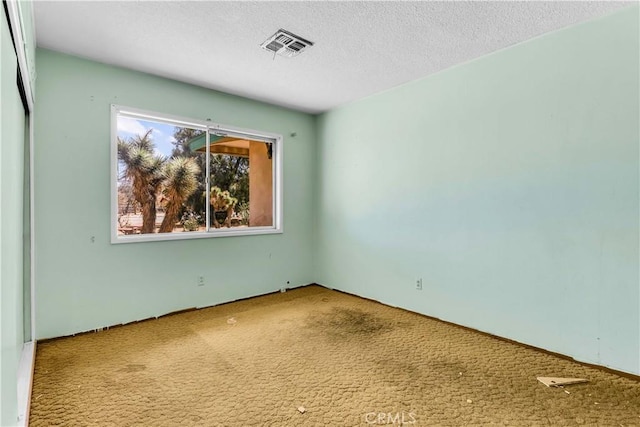 57136 Navajo Trl, Yucca Valley, CA 92284 - carpeted spare room with a textured ceiling