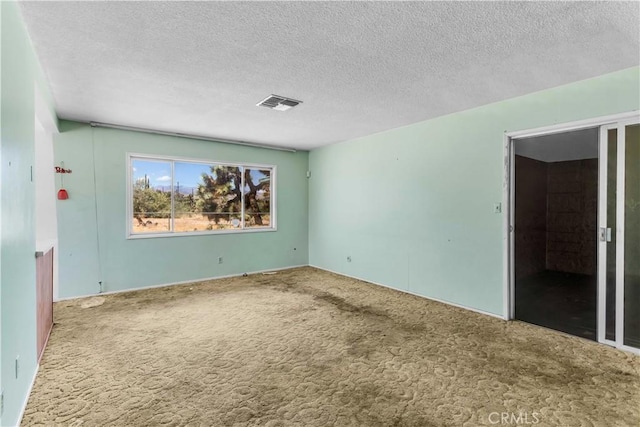 57136 Navajo Trl, Yucca Valley, CA 92284 - carpeted spare room featuring a textured ceiling