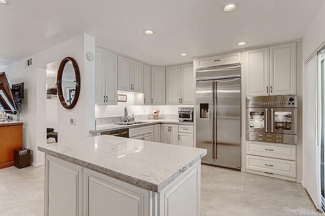 4014 Aguila St Unit F, Carlsbad, CA 92008 - kitchen featuring stainless steel appliances, recessed lighting, light tile patterned floors, light stone countertops, and white cabinets