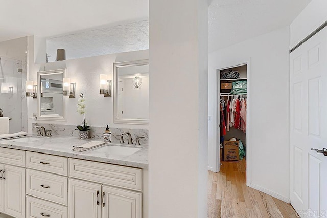 4014 Aguila St Unit F, Carlsbad, CA 92008 - full bath featuring double vanity, wood finished floors, a spacious closet, and a shower