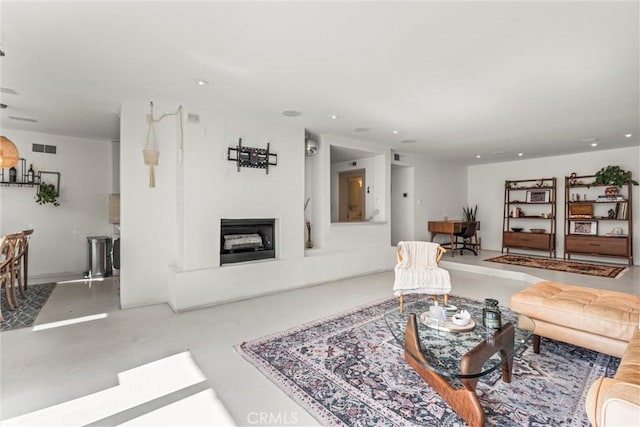 1230 Horn Ave Unit 101, West Hollywood, CA 90069 - living room with recessed lighting, finished concrete floors, and a fireplace with raised hearth