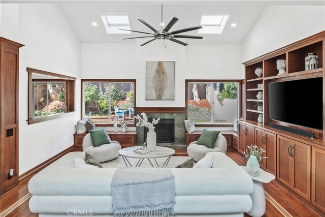 9 Aberdeen St, Irvine, CA 92620 - living area featuring a skylight, wood finished floors, a premium fireplace, healthy amount of natural light, and high vaulted ceiling