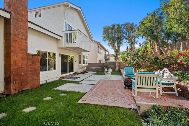 9 Aberdeen St, Irvine, CA 92620 - back of house with an outdoor fire pit, a patio area, stucco siding, and a balcony