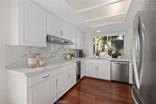 9 Aberdeen St, Irvine, CA 92620 - kitchen with stainless steel appliances, under cabinet range hood, beverage cooler, and white cabinets