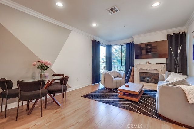 6938 Laurel Canyon Blvd Unit 101, North Hollywood, CA 91605 - living area with a glass covered fireplace, light wood finished floors, recessed lighting, and crown molding