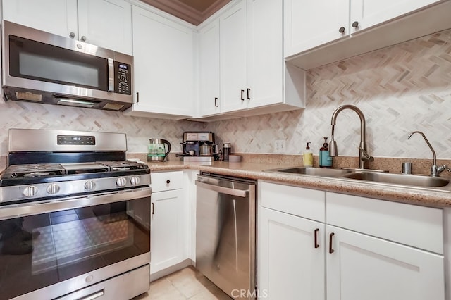 6938 Laurel Canyon Blvd Unit 101, North Hollywood, CA 91605 - kitchen with appliances with stainless steel finishes, light countertops, white cabinets, and decorative backsplash