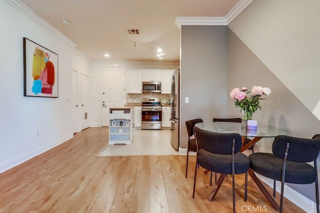 6938 Laurel Canyon Blvd Unit 101, North Hollywood, CA 91605 - dining area with light wood finished floors, ornamental molding, and recessed lighting