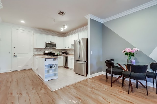 6938 Laurel Canyon Blvd Unit 101, North Hollywood, CA 91605 - kitchen with appliances with stainless steel finishes, white cabinetry, light wood-style flooring, ornamental molding, and recessed lighting