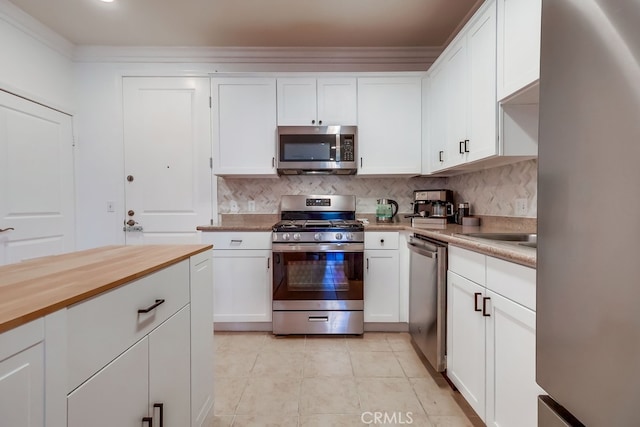 6938 Laurel Canyon Blvd Unit 101, North Hollywood, CA 91605 - kitchen with stainless steel appliances, decorative backsplash, white cabinets, and light tile patterned floors