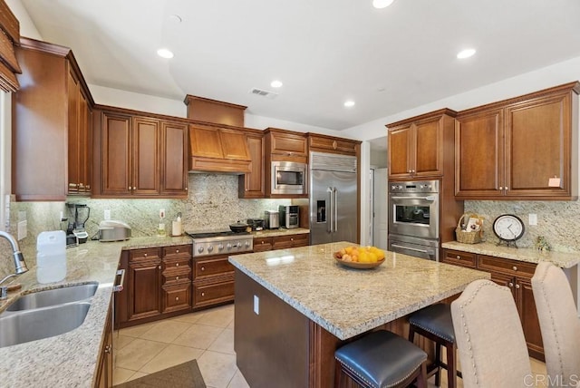 16210 Bluestar Way, San Diego, CA 92127 - kitchen with built in appliances, decorative backsplash, a kitchen island, light stone countertops, and light tile patterned floors