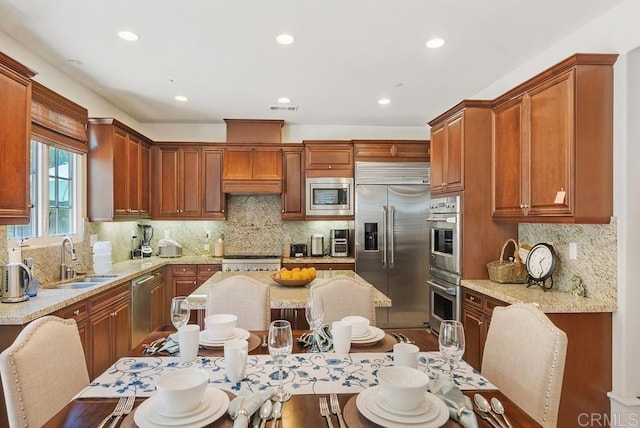 16210 Bluestar Way, San Diego, CA 92127 - kitchen with built in appliances, tasteful backsplash, recessed lighting, light stone countertops, and brown cabinetry