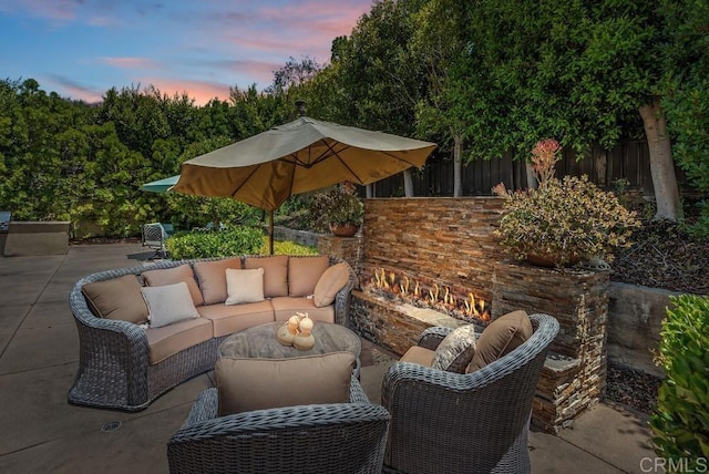 16210 Bluestar Way, San Diego, CA 92127 - patio terrace at dusk with an outdoor living space with a fireplace and a patio area