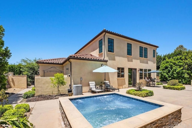16210 Bluestar Way, San Diego, CA 92127 - rear view of property with a tiled roof, stucco siding, a gate, a patio, and a hot tub