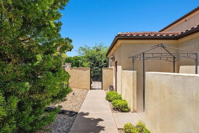 16210 Bluestar Way, San Diego, CA 92127 - view of home's exterior with a gate, stucco siding, and a tiled roof