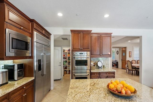 16210 Bluestar Way, San Diego, CA 92127 - kitchen with built in appliances, light stone countertops, light tile patterned floors, recessed lighting, and tasteful backsplash