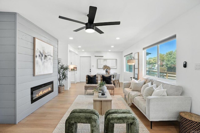 4862 Kesling Ct, San Diego, CA 92117 - living room with a ceiling fan, a wall mounted AC, a fireplace, light wood-style floors, and recessed lighting
