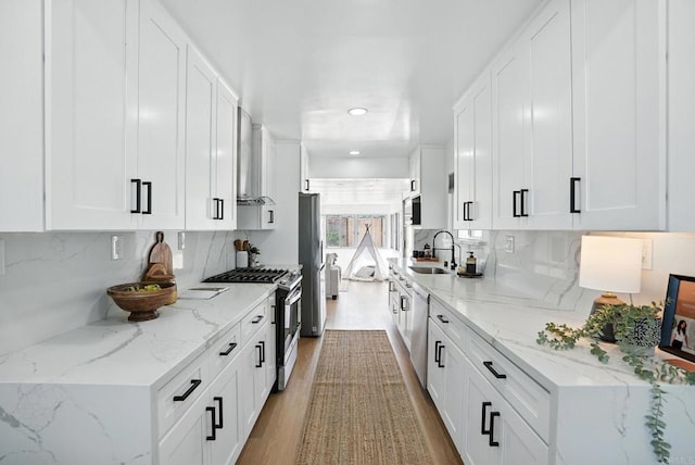 4862 Kesling Ct, San Diego, CA 92117 - kitchen featuring stainless steel appliances, white cabinets, backsplash, light wood-style flooring, and recessed lighting