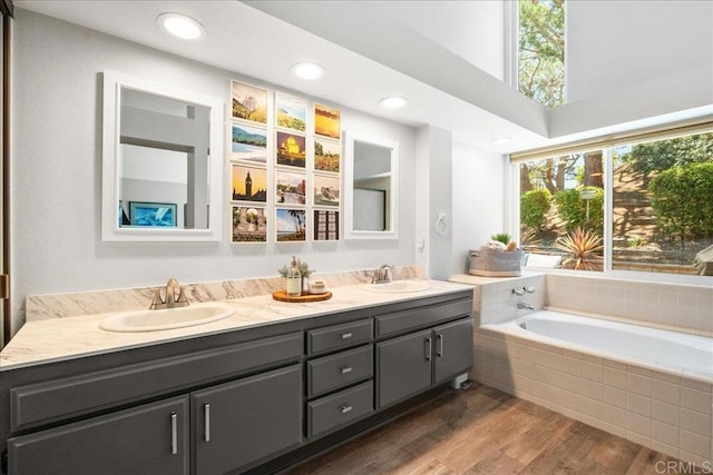 1879 Falconer Ct, Vista, CA 92081 - bathroom with double vanity, a bath, wood finished floors, and recessed lighting