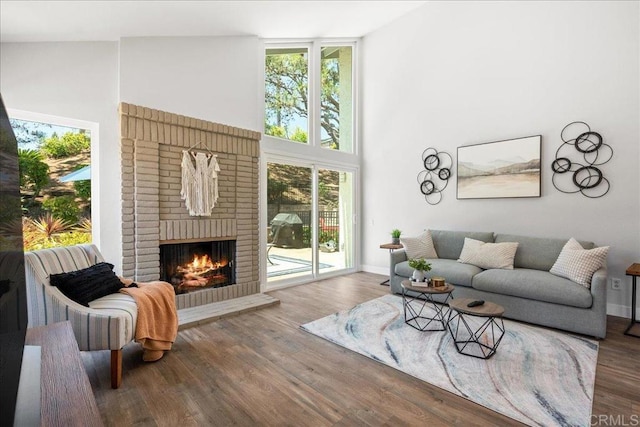 1879 Falconer Ct, Vista, CA 92081 - living room featuring a brick fireplace and wood finished floors