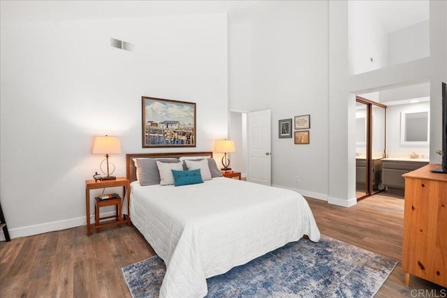 1879 Falconer Ct, Vista, CA 92081 - bedroom with a high ceiling, wood finished floors, and connected bathroom