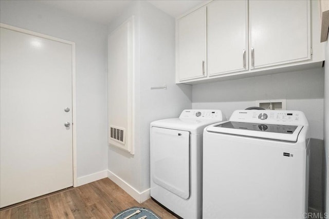 1879 Falconer Ct, Vista, CA 92081 - laundry area featuring washing machine and dryer, wood finished floors, and cabinet space