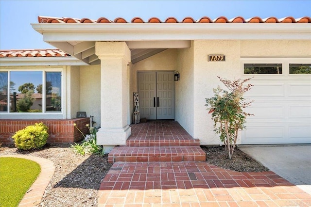 1879 Falconer Ct, Vista, CA 92081 - property entrance featuring stucco siding, a tile roof, and a garage