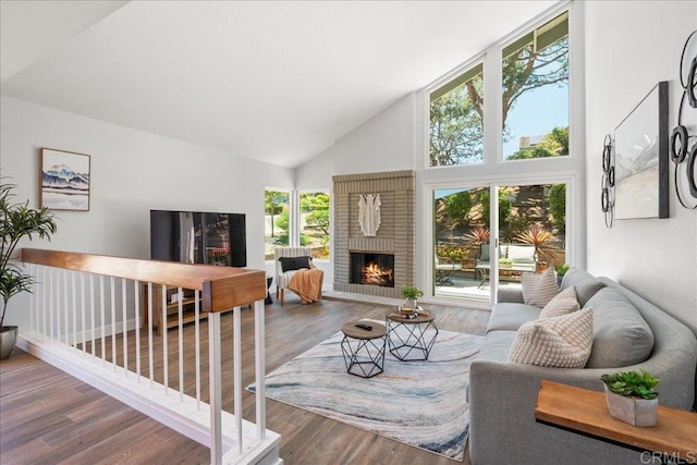 1879 Falconer Ct, Vista, CA 92081 - living room with high vaulted ceiling, wood finished floors, and a brick fireplace