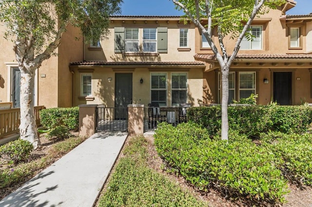 10667 Golden Willow Unit 152, San Diego, CA 92130 - multi unit property with stucco siding, a gate, a fenced front yard, and a tiled roof
