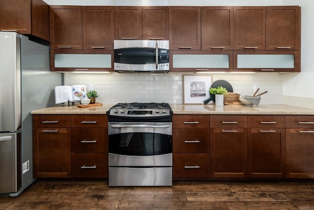 10667 Golden Willow Unit 152, San Diego, CA 92130 - kitchen featuring stainless steel appliances, dark wood-type flooring, light stone counters, and tasteful backsplash