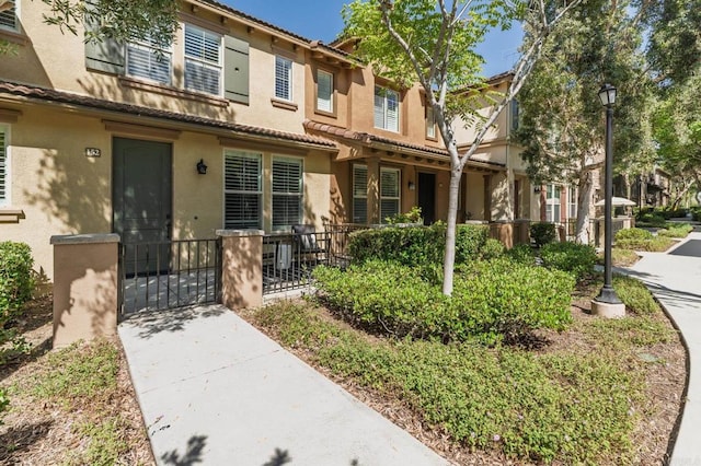10667 Golden Willow Unit 152, San Diego, CA 92130 - view of property featuring stucco siding and a tiled roof
