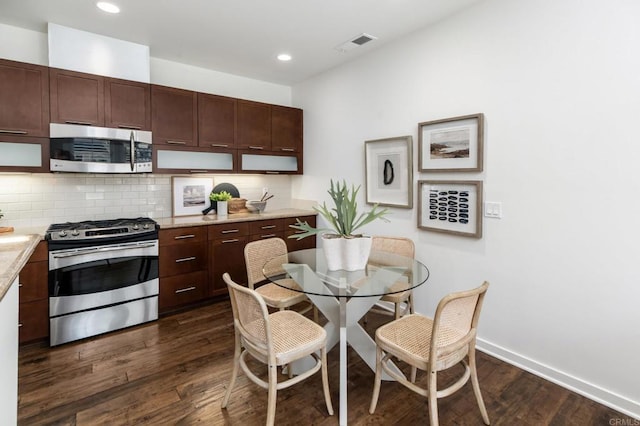 10667 Golden Willow Unit 152, San Diego, CA 92130 - kitchen with appliances with stainless steel finishes, dark wood-style floors, backsplash, recessed lighting, and dark brown cabinets