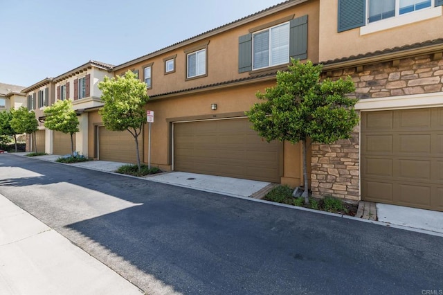 10667 Golden Willow Unit 152, San Diego, CA 92130 - townhome / multi-family property with an attached garage, stone siding, and stucco siding