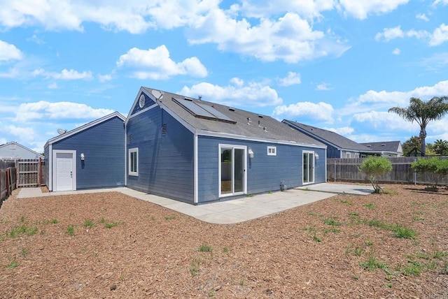3939 Magnolia Rd, Oceanside, CA 92058 - back of house with a patio area, roof mounted solar panels, and a fenced backyard