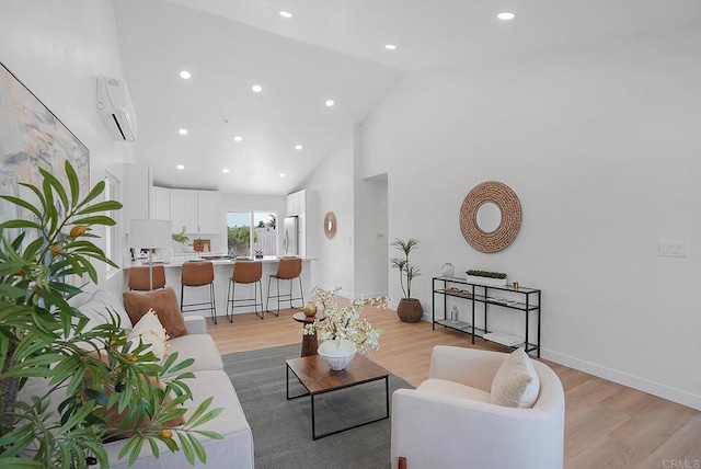 3939 Magnolia Rd, Oceanside, CA 92058 - living area with a wall mounted AC, light wood finished floors, high vaulted ceiling, and recessed lighting