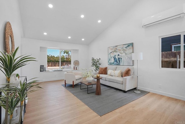 3939 Magnolia Rd, Oceanside, CA 92058 - living area featuring a wall unit AC, recessed lighting, light wood-style flooring, and high vaulted ceiling