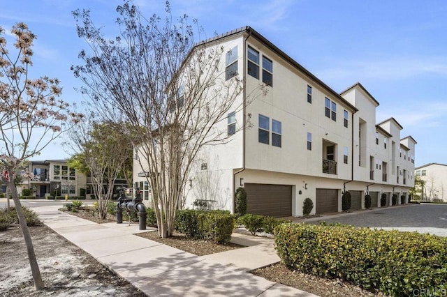 16755 Coyote Bush Dr Unit 15, San Diego, CA 92127 - view of building exterior with an attached garage and a residential view