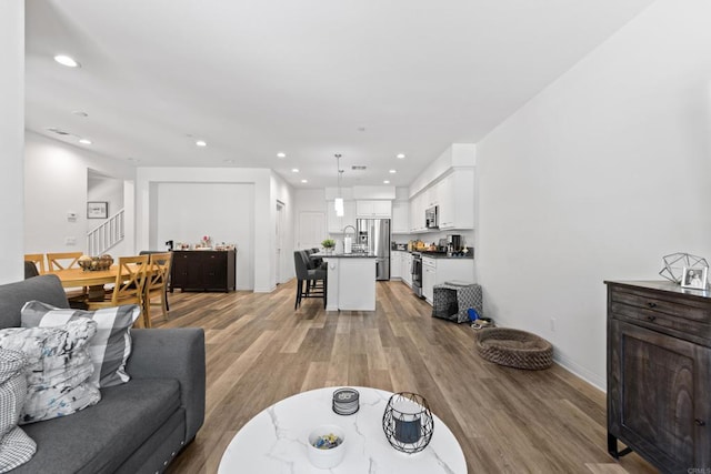 1925 Avenida Senecio Unit 2, Chula Vista, CA 91913 - living room featuring recessed lighting, stairs, and light wood-style flooring