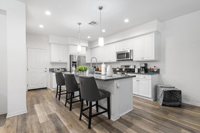 1925 Avenida Senecio Unit 2, Chula Vista, CA 91913 - kitchen featuring stainless steel appliances, white cabinetry, an island with sink, a breakfast bar area, and recessed lighting