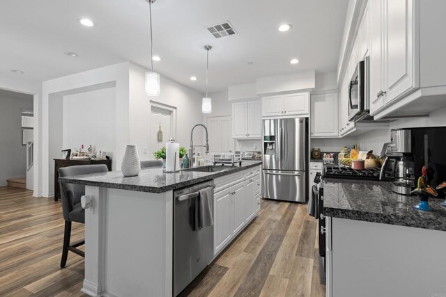 1925 Avenida Senecio Unit 2, Chula Vista, CA 91913 - kitchen with appliances with stainless steel finishes, white cabinetry, light wood-style flooring, and recessed lighting