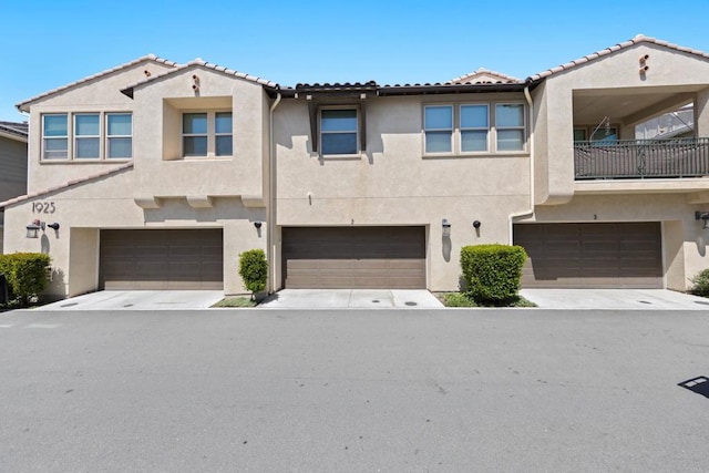 1925 Avenida Senecio Unit 2, Chula Vista, CA 91913 - view of property featuring a garage, stucco siding, and a tile roof