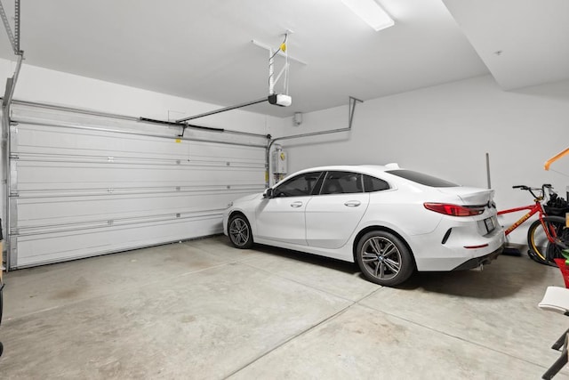 1925 Avenida Senecio Unit 2, Chula Vista, CA 91913 - garage featuring a garage door opener and water heater