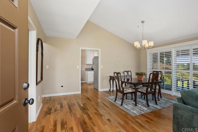 2072 Golden Circle Dr, Escondido, CA 92026 - dining room featuring a chandelier, wood finished floors, and lofted ceiling