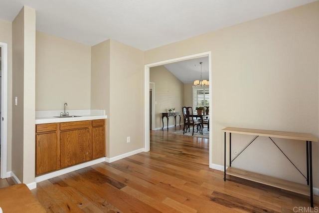 2072 Golden Circle Dr, Escondido, CA 92026 - bar featuring light wood-style floors, a chandelier, and lofted ceiling